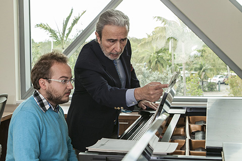 Frost faculty member, Santiago Rodriguez, teaching piano to a student